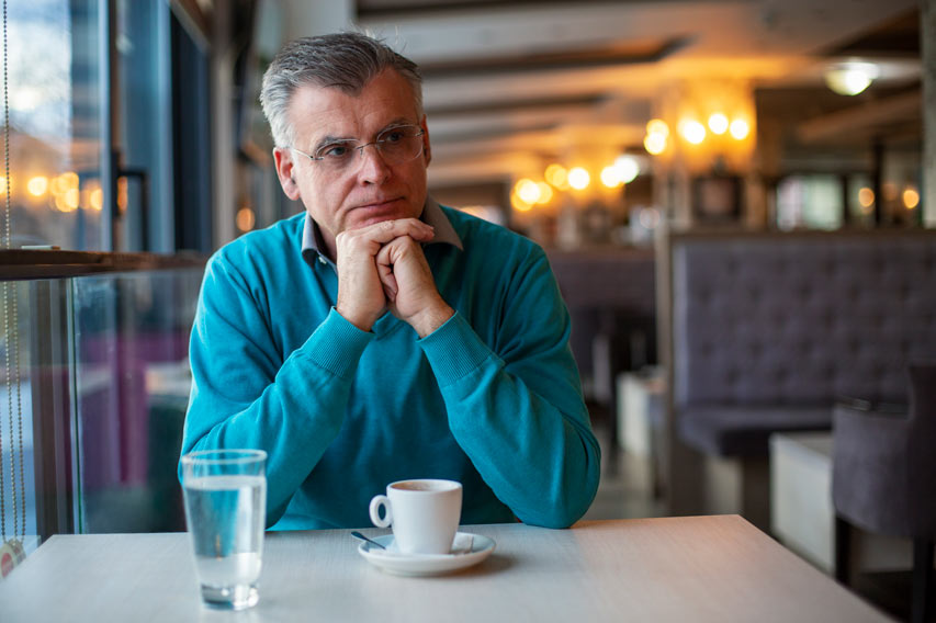 Man sitting in restaurant with a cup of coffee