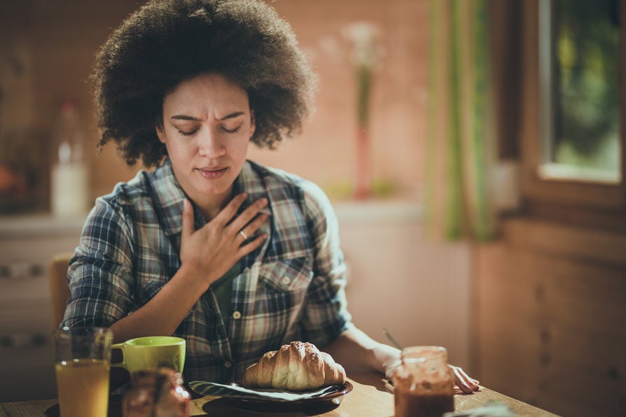 Female looking uncomfortable at breakfast