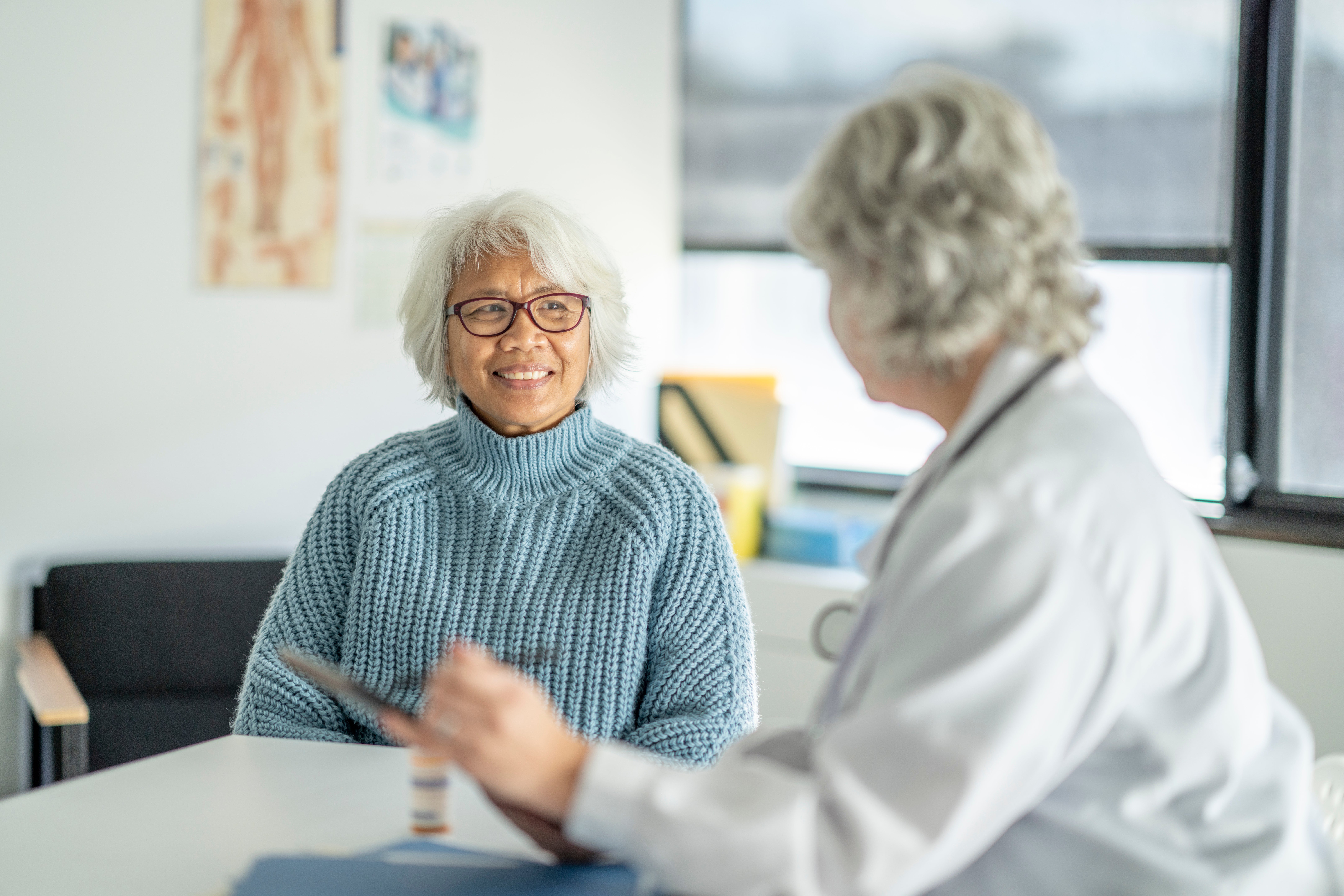 An older woman talks with her doctor