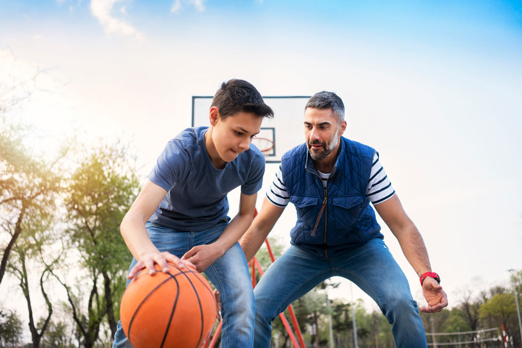 Father and son playing basketball