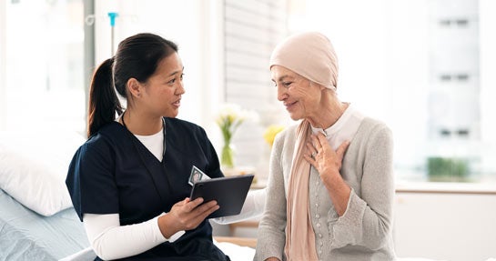 Tablet, nurse and woman with cancer patient, elderly