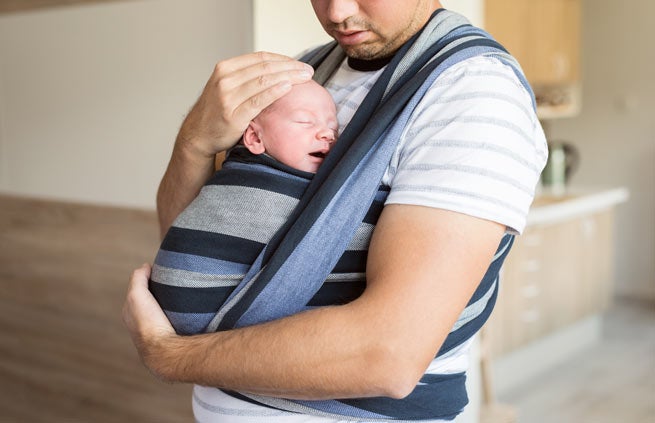 Dad wearing a baby in a carrier