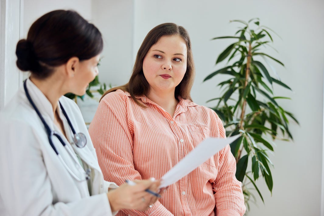 A plus size woman talks with her doctor
