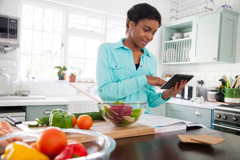 Woman planning meals in kitchen