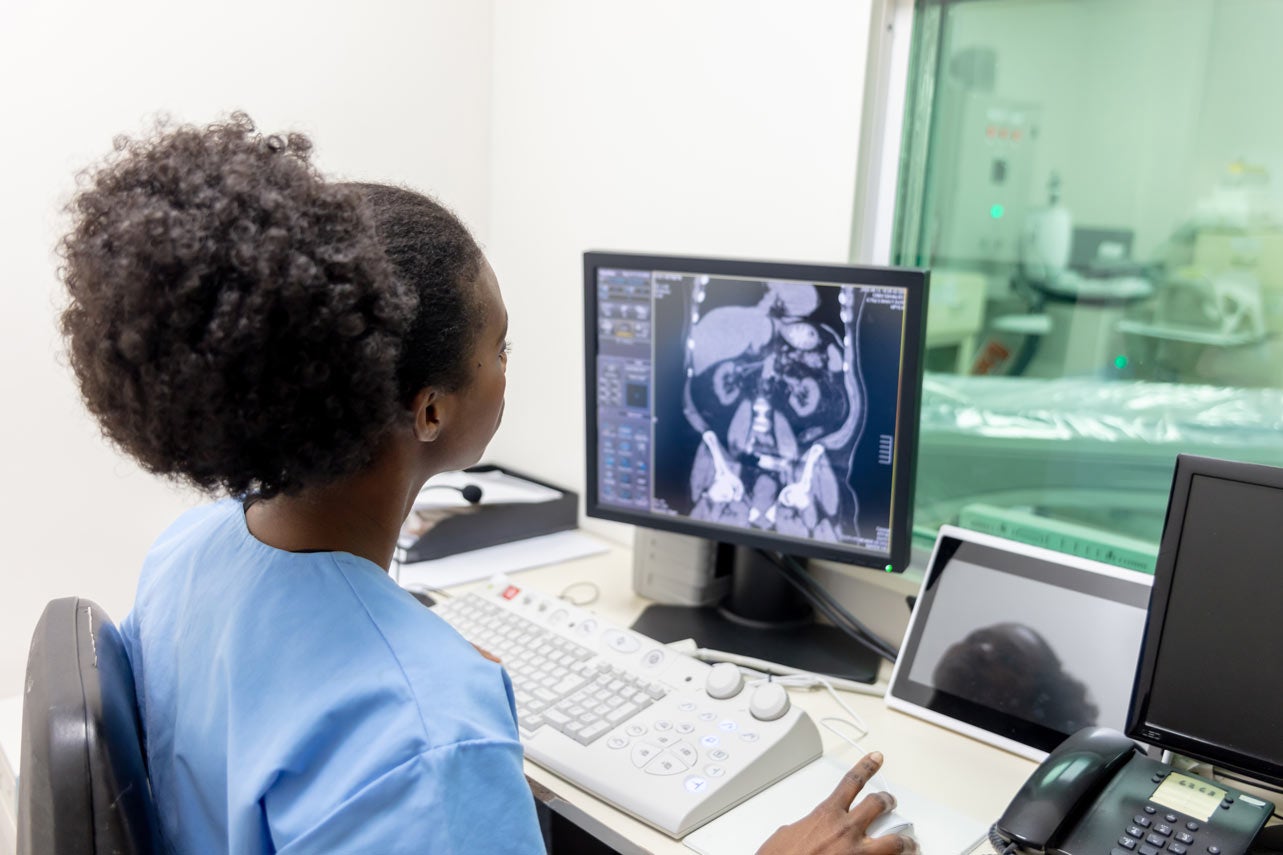 Technician looks at CT scan screen - CT Scan of the Abdomen article