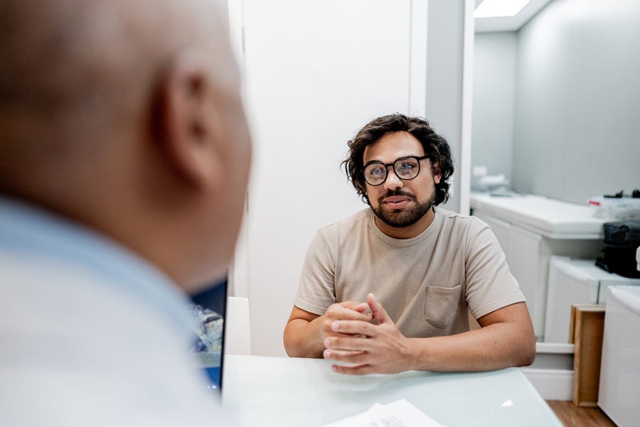 Mid adult man talking with doctor at doctor's office