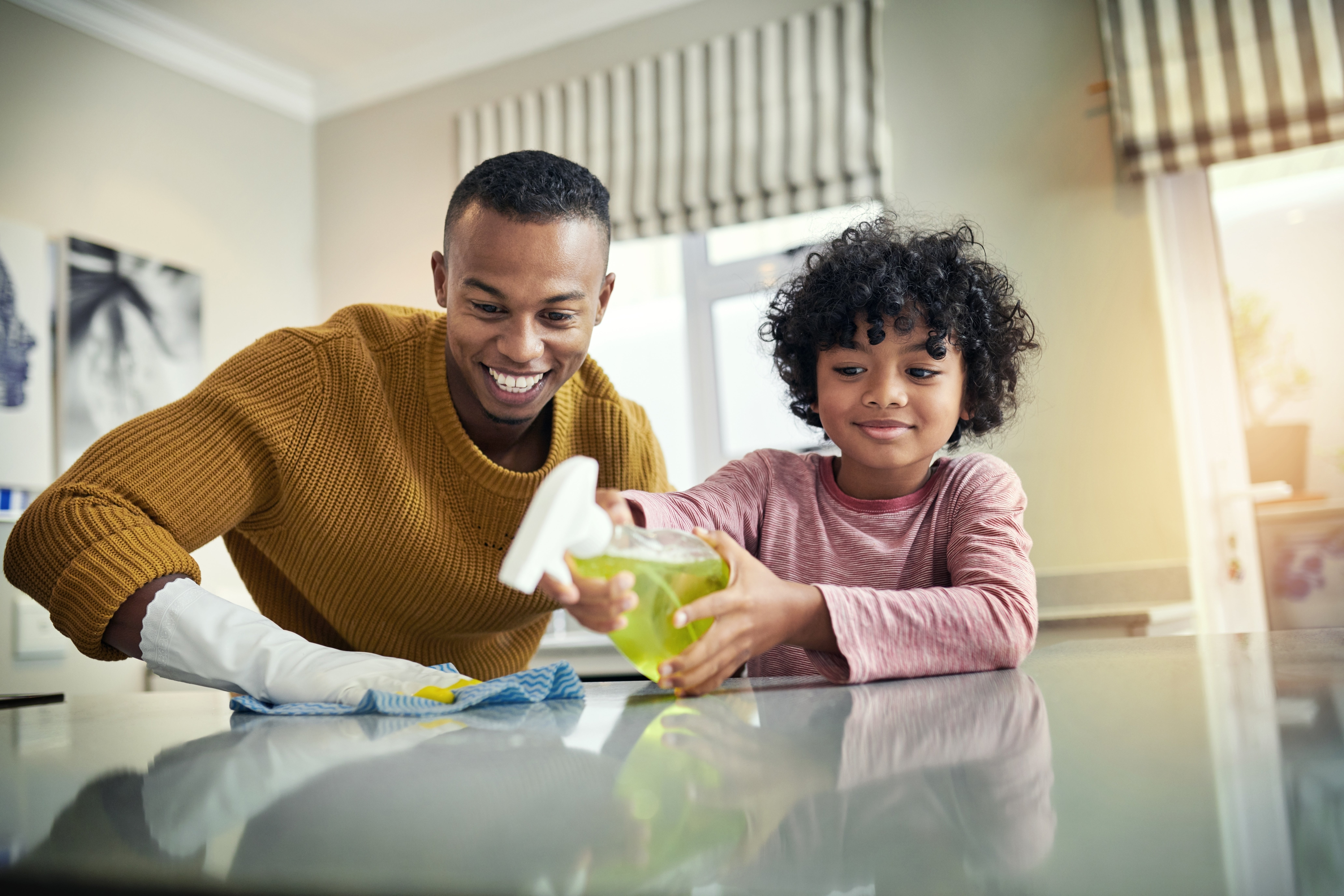A father and child clean their home together