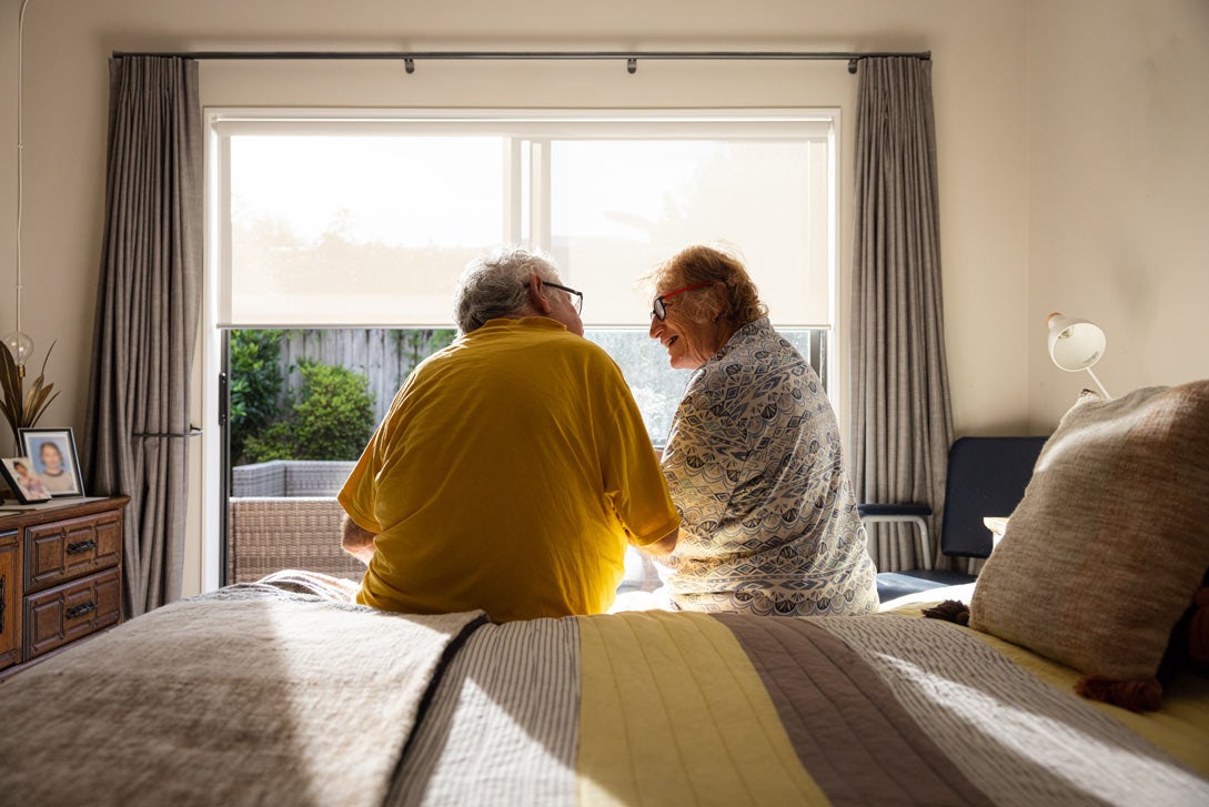 An older couple shares a happy moment, relaxing at home