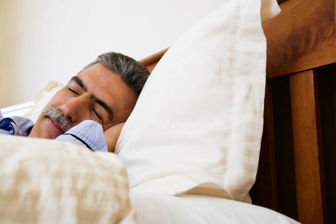 Middle-aged man sleeping in bed