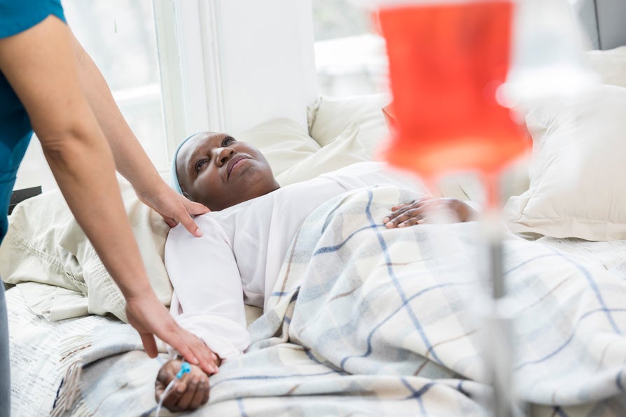 Hospice nurse checks on female patient