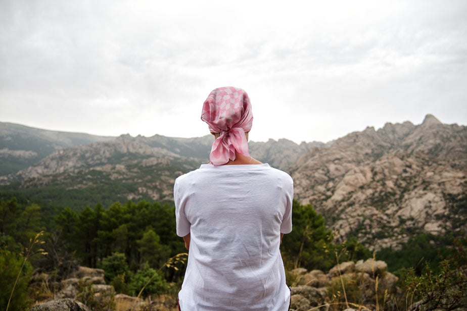 Woman with cancer sitting in a natural space